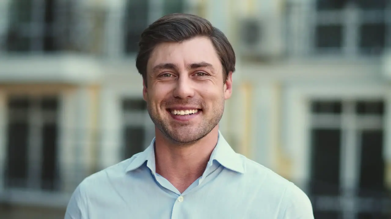 Portrait man smiling on camera at street Businessman looking at camera outdoor