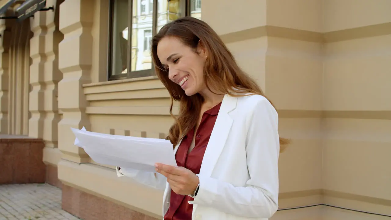 Excited woman enjoy success at street Focused business woman reading documents