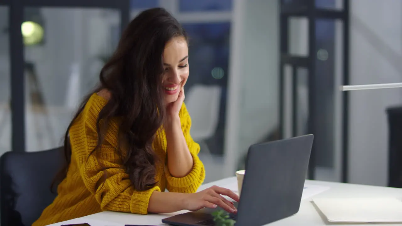 Closeup smiling businesswoman working laptop in office Pretty woman typing text