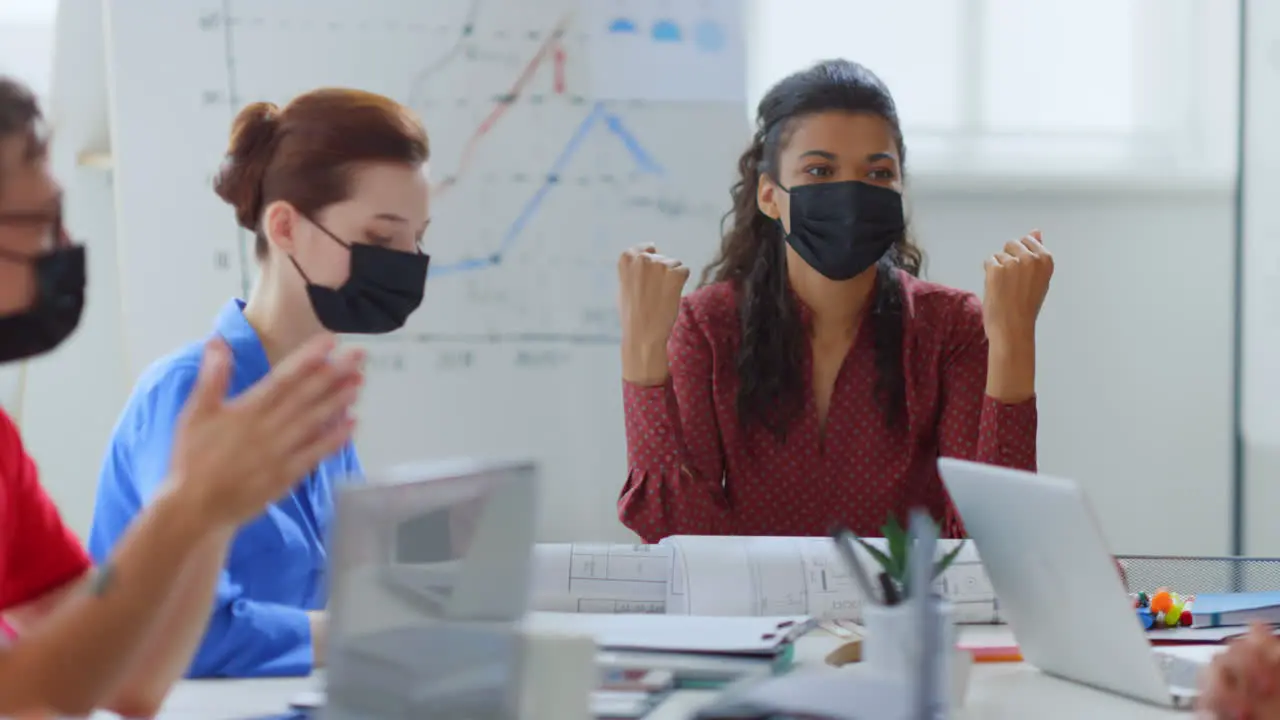 Businesswoman brainstorming with colleagues Masked people sitting table office