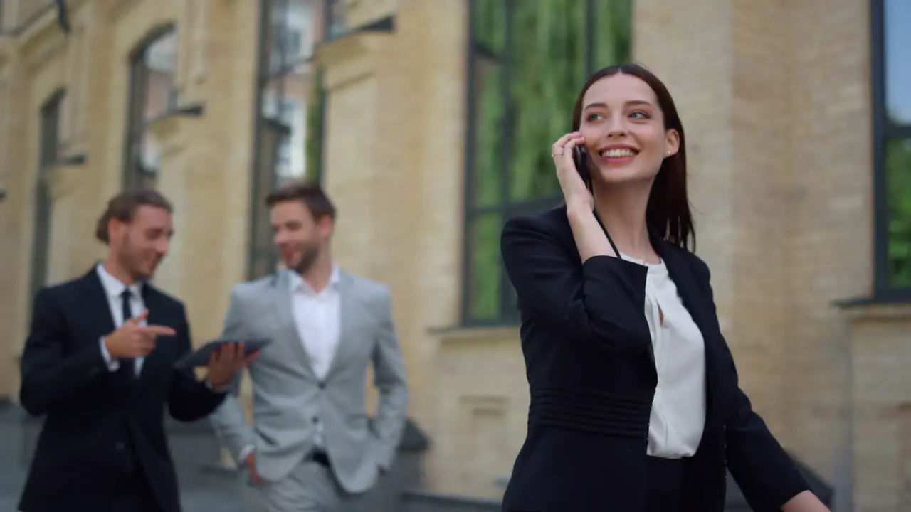 Smiling woman using mobile phone outdoors Business people rushing work