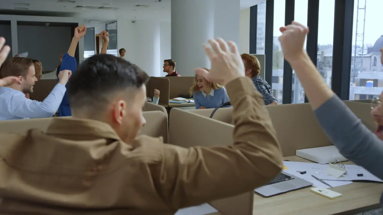 Business team celebrating new project in office Managers giving high five