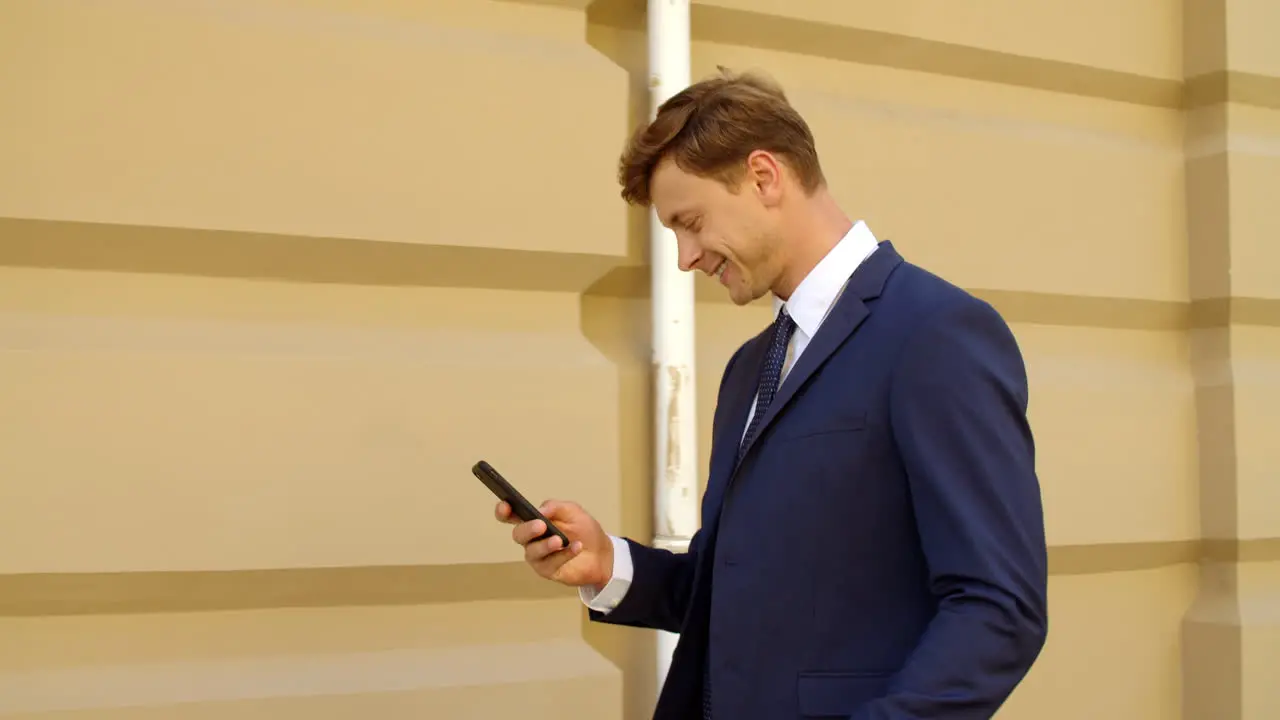 Happy business man celebrating success outdoors Excited businessman