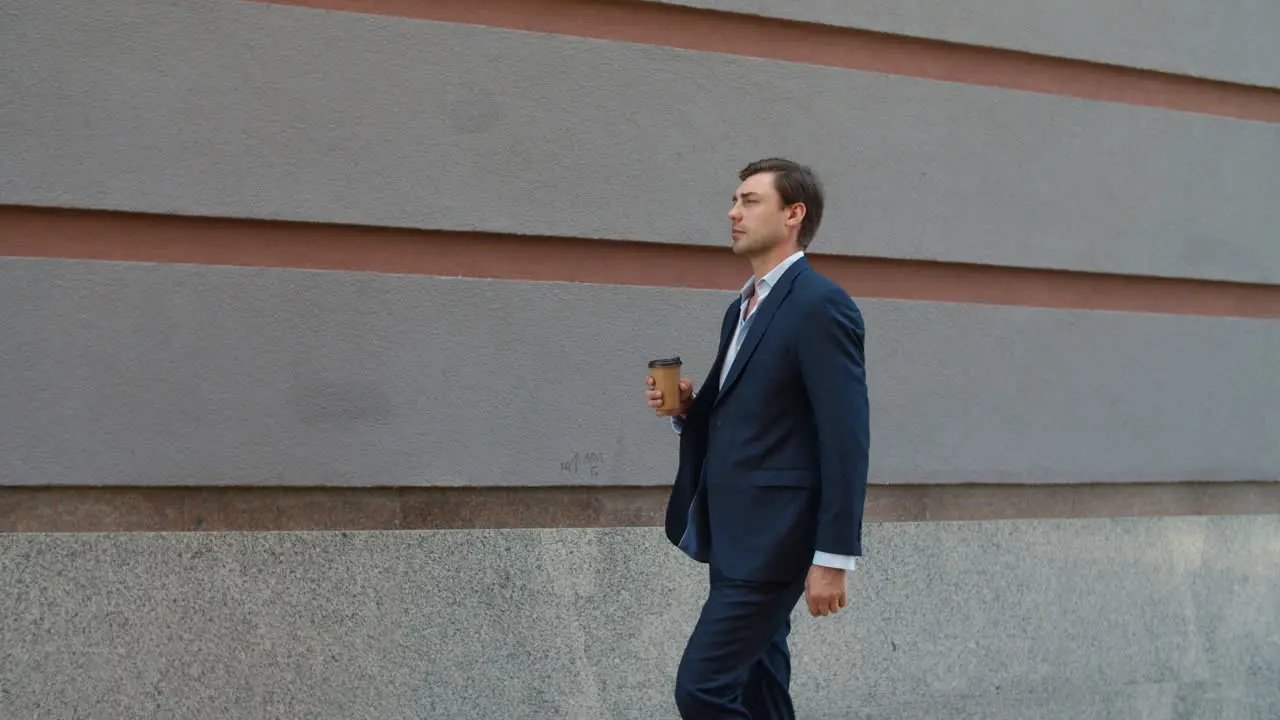 Side view man drinking coffee to go Man going to work with coffee outdoor