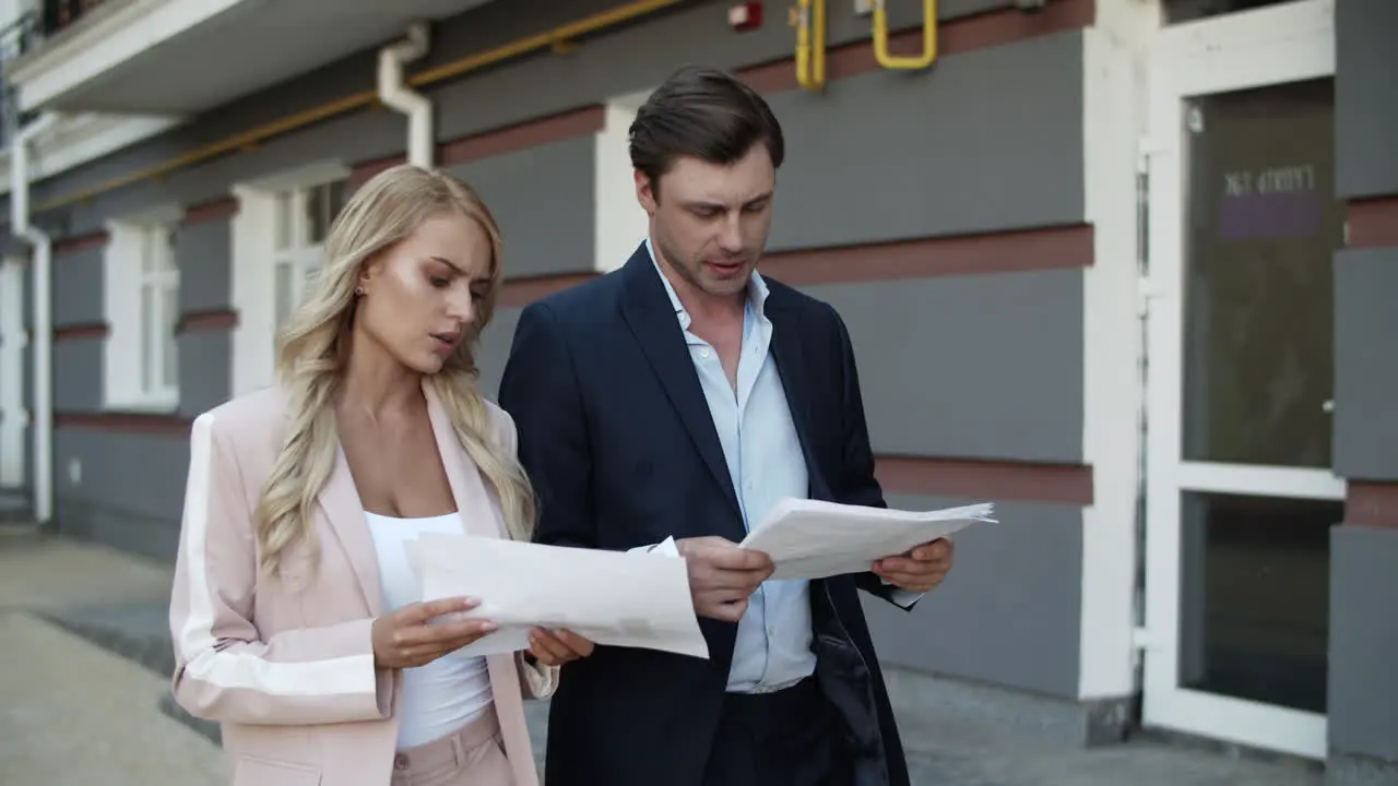 Business couple discussing documents Business partners analyzing paperwork