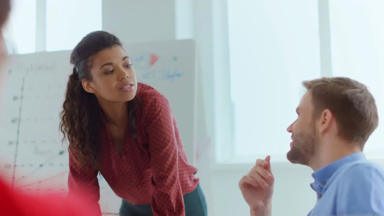 African woman arguing young man office Business people discussing indoors