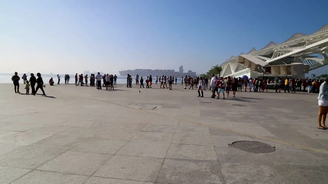 People walking around at Praca Maua at sunset in the center of Rio de Janeiro Brazil