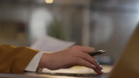 Close Up Of Businesswoman In Office Reviewing And Making Notes On Application Or CV For Job Vacancy 3