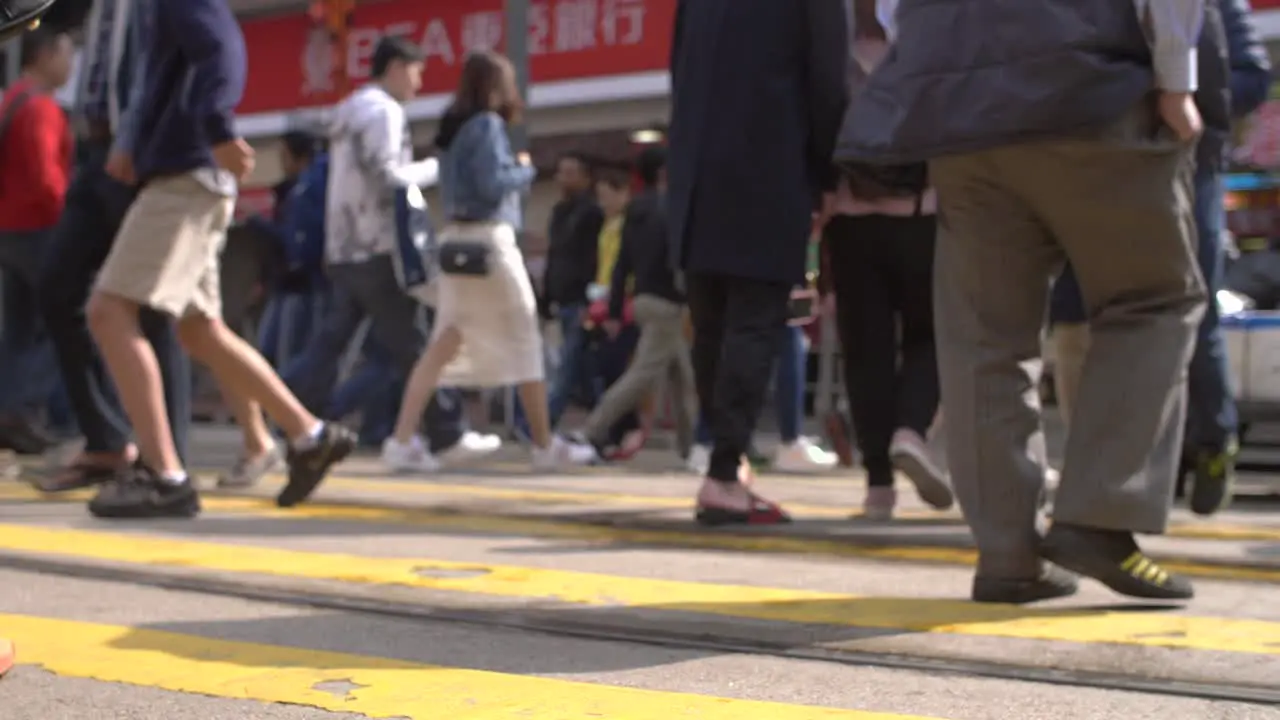 Legs of Crowd Crossing Road