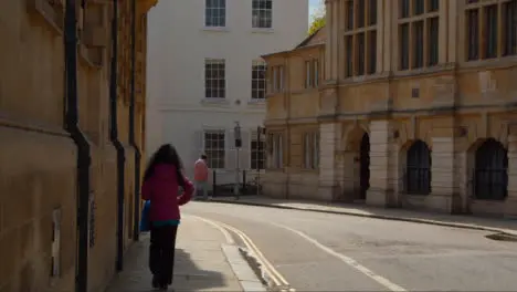 Tracking Shot Following Person Walking Down Quiet Street