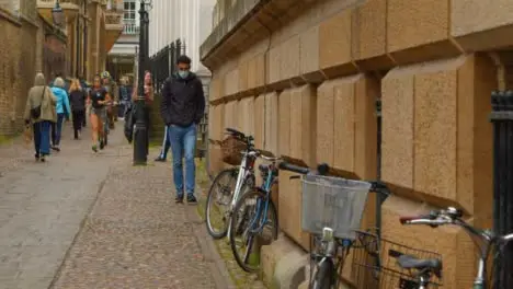 Tracking Shot Revealing Pedestrians On Quaint Old English Street 