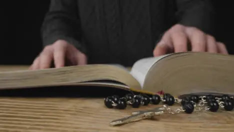 Tracking Shot of a Crucifix with a Bible