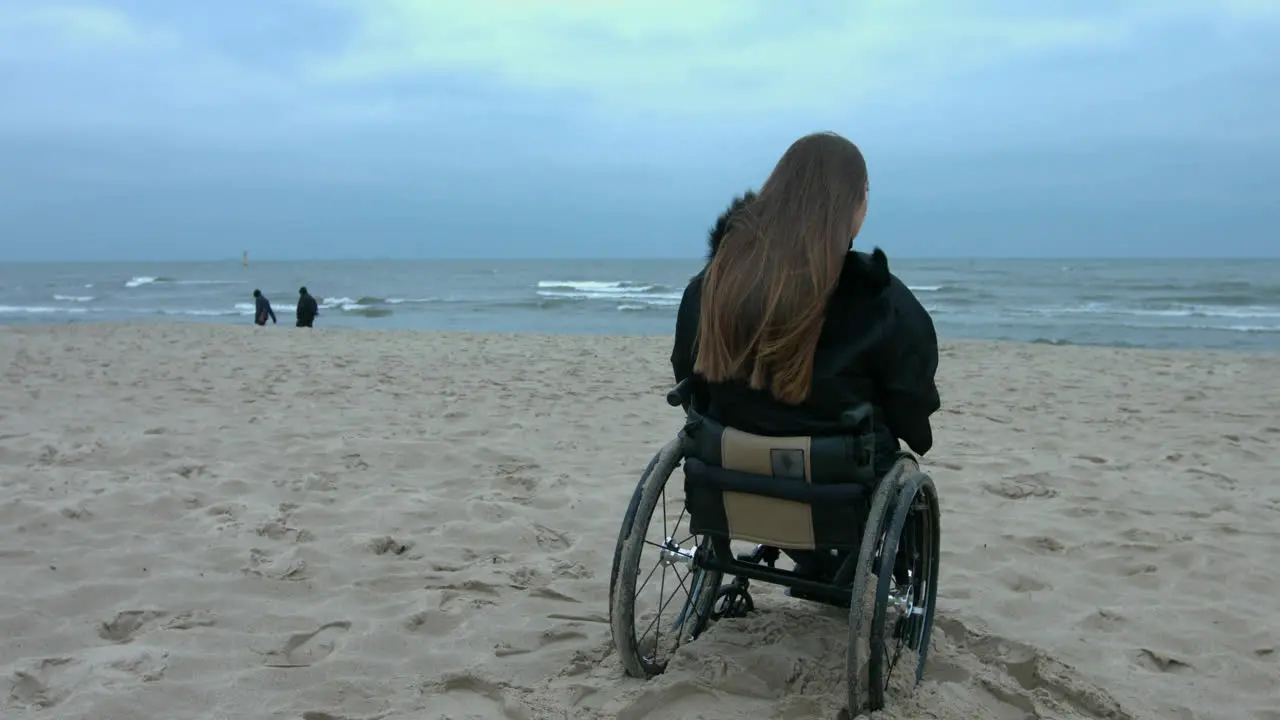 A disabled woman in a quiet pensive moment