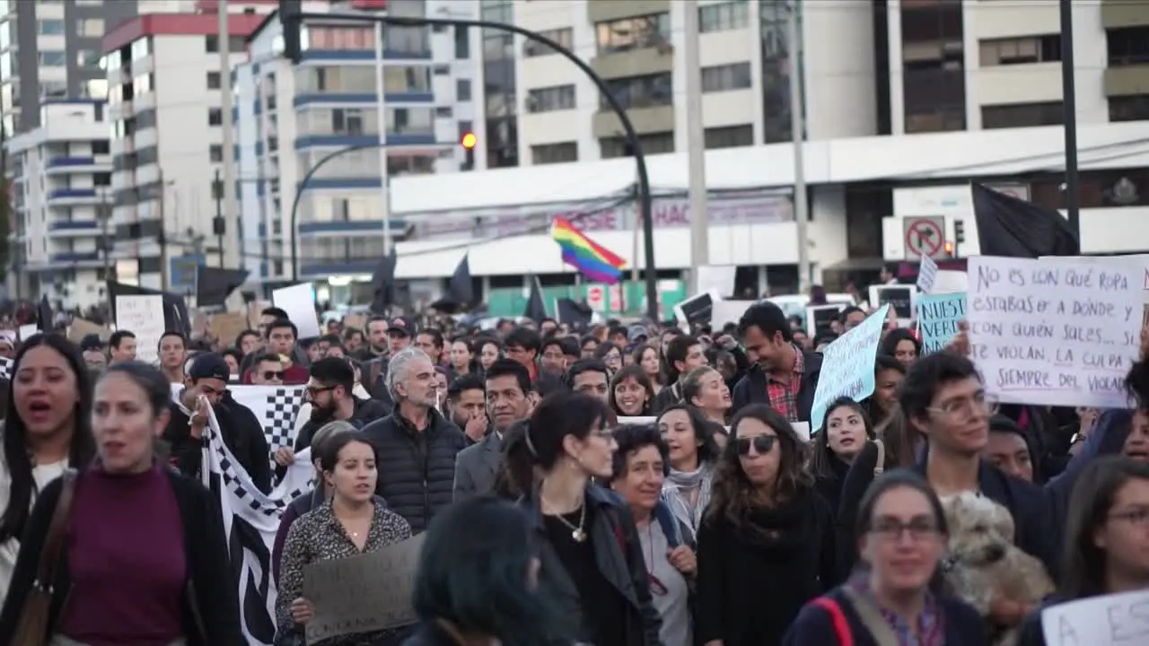 In Quito Ecuador women and men are peacefully protesting marching and chanting songs against inequality marches in favor of women rights with messages written on boards