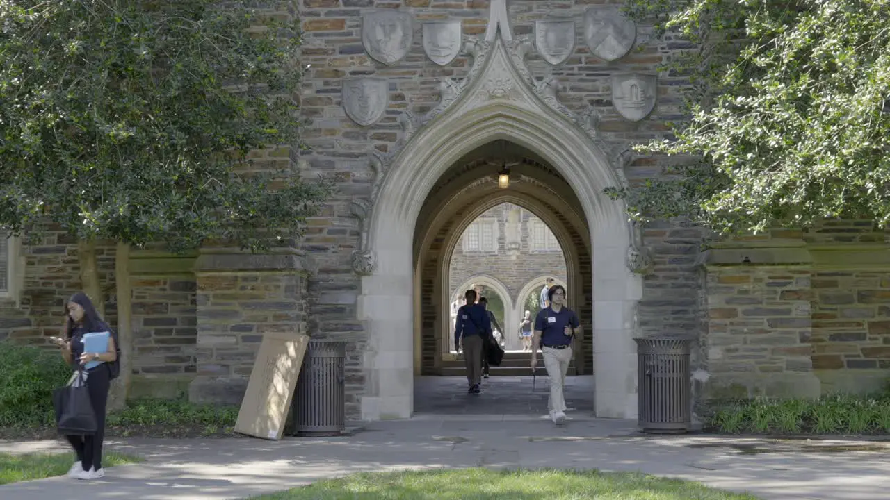 Students walk across campus on a bright sunny day