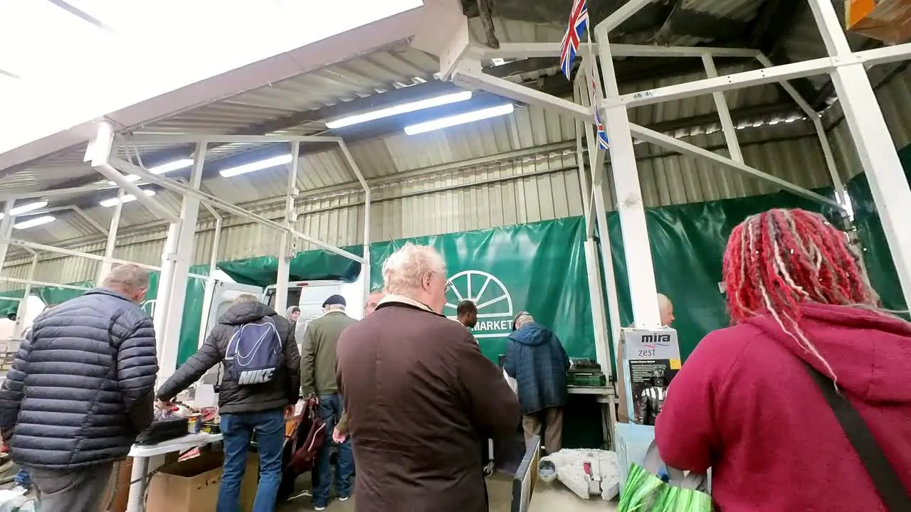 POV looking around British flea market at variety of junk and unwanted objects for a cheap bargain