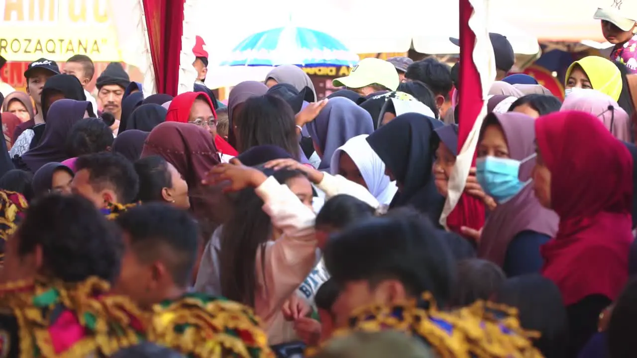 A crowd of spectators is watching a performance Indonesia