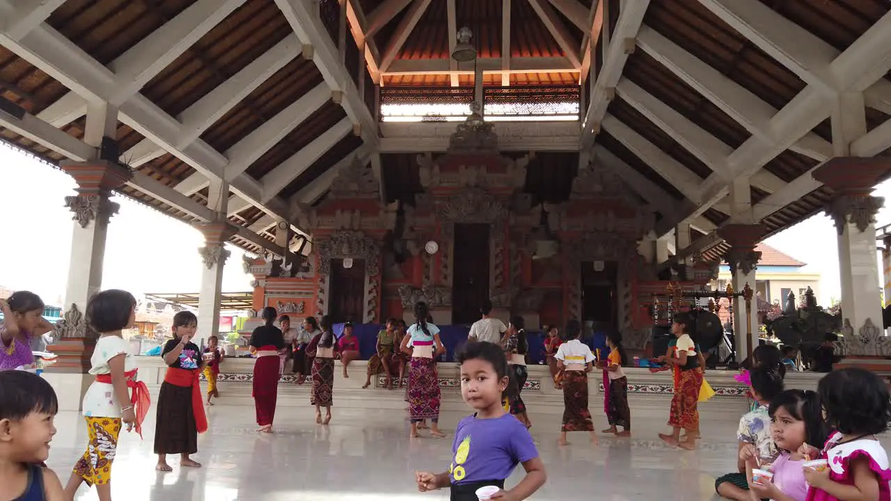 Balinese Dance Class Rehearsal For Children Little Girls with Traditional Clothes Practice Legong Choreography at the Banjar Building in Sukawati Bali Indonesia