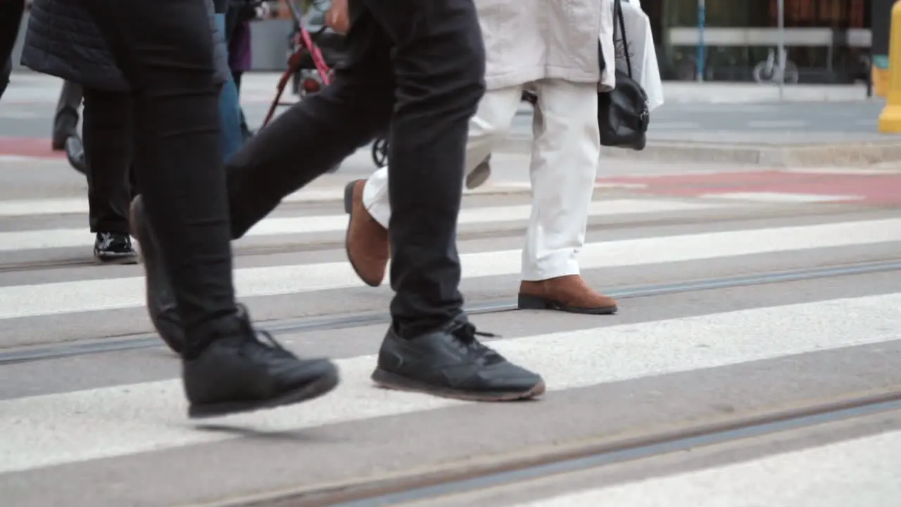 People in the city cross the road close up