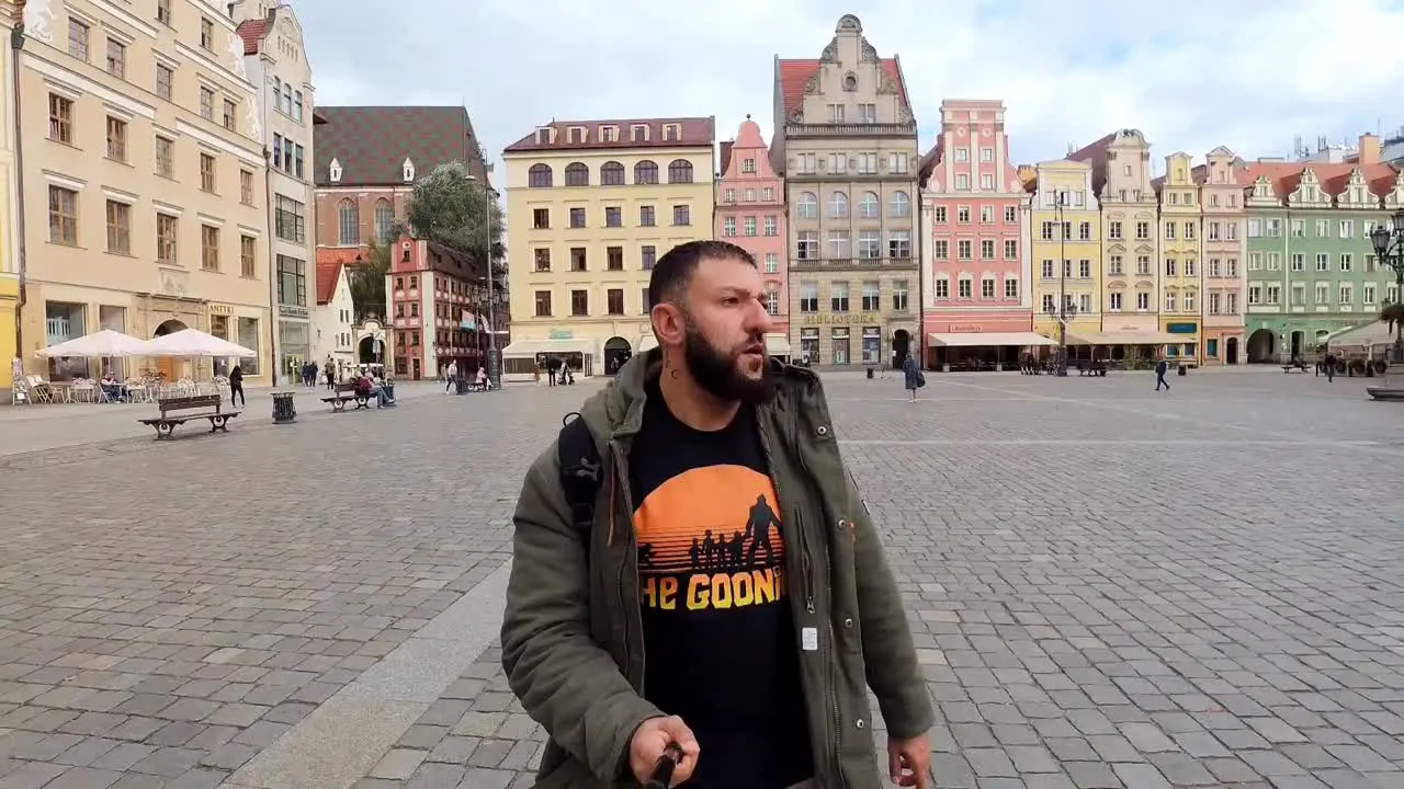 man walking through the city center of wroclaw