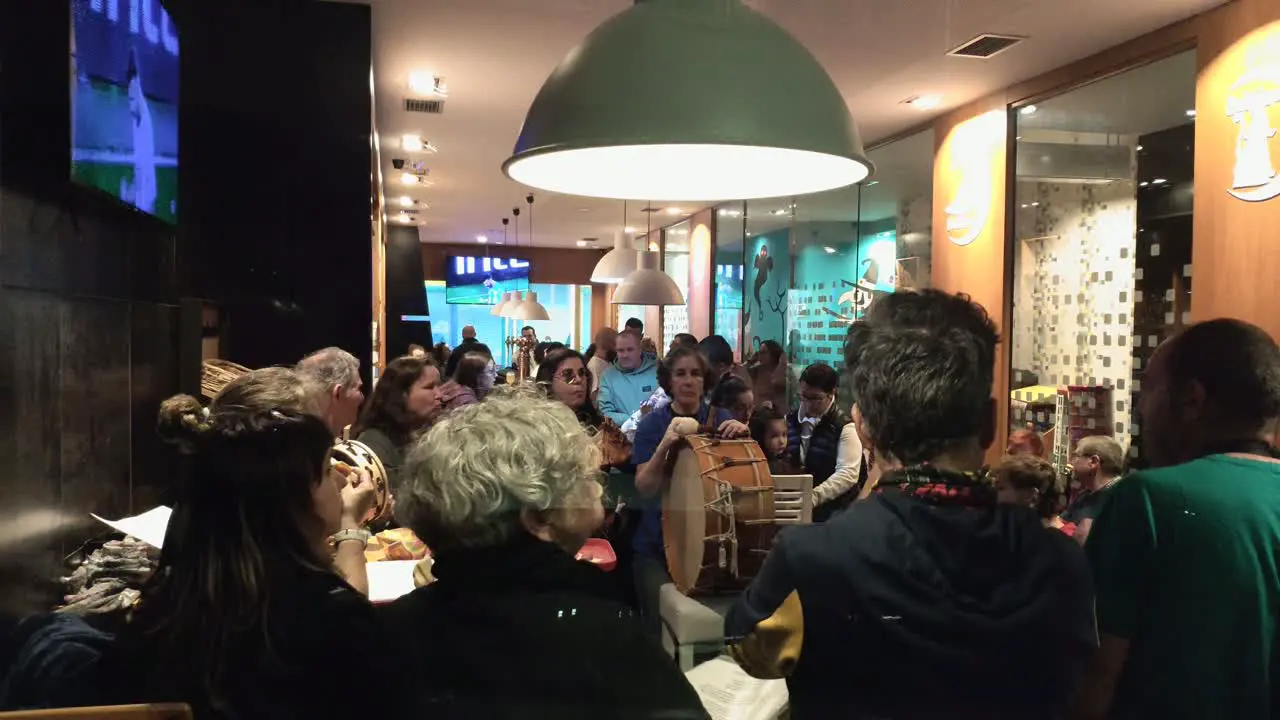 musicians with instruments taking a break in a busy bar with live music lots of people enjoying at the end of the week spotted shot out of focus Ordes Galicia Spain