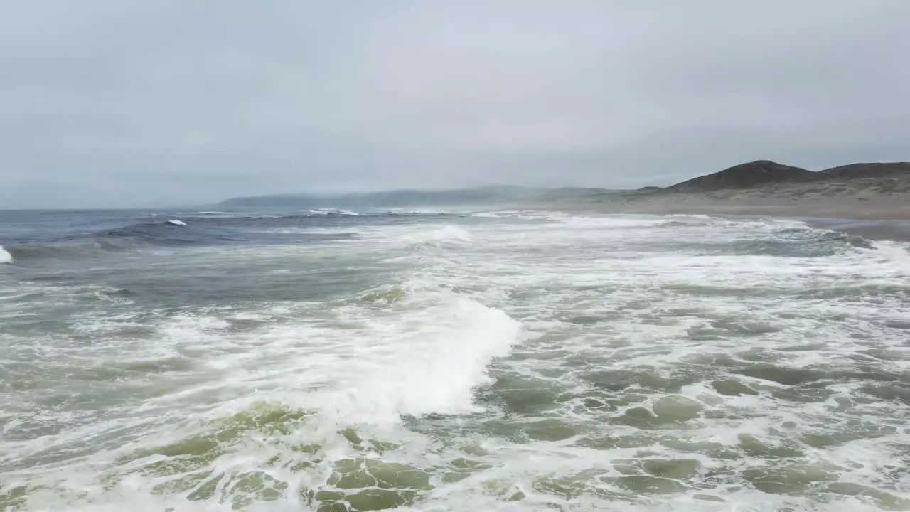 Pullback Shot Of Waves Splashing In Blue Wide Ocean Cool Breeze California