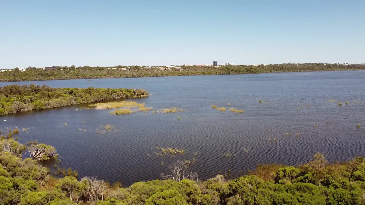 The blue water and surrounding foliage of Lake Joondalup in Australia