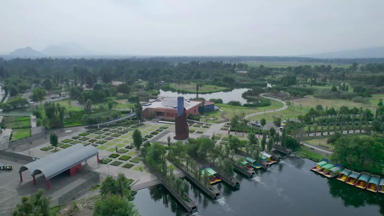 Orbital footage above a lake with view of trajineras a highway and a natural area in Xochimilco Mexico City