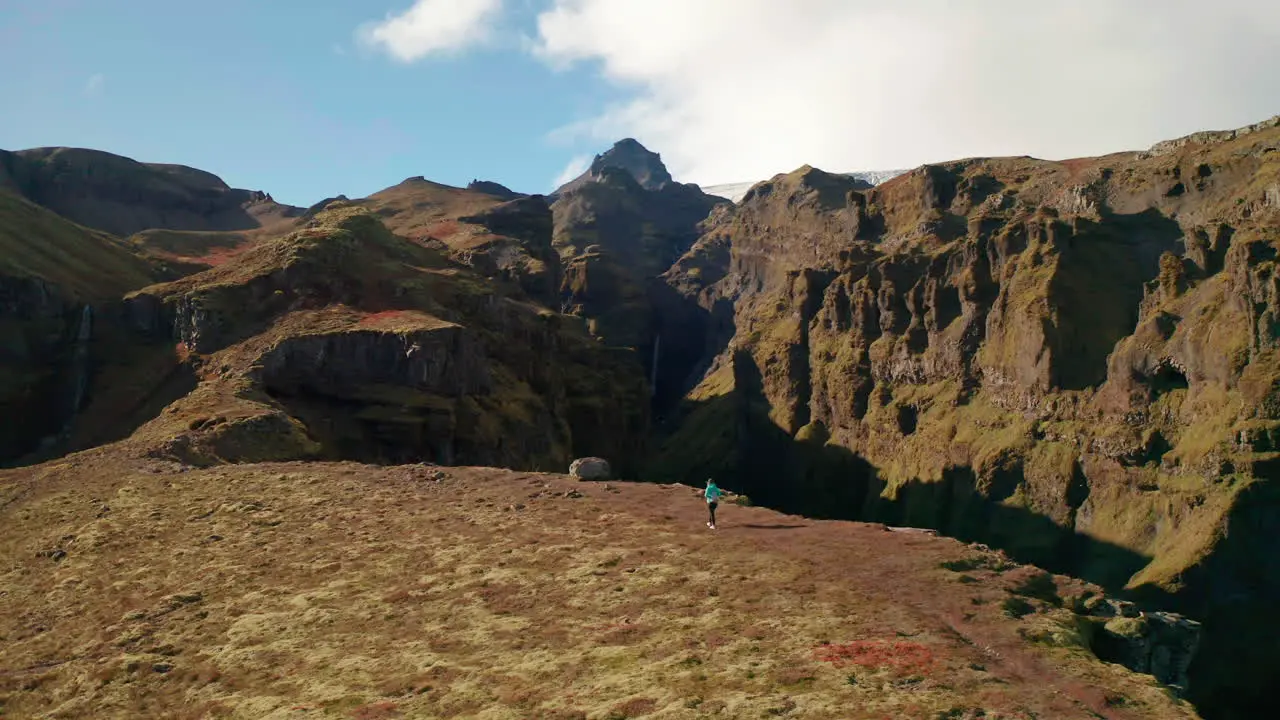 Tourist walking by the edge of the Mulagjufur Canyon in South Iceland aerial