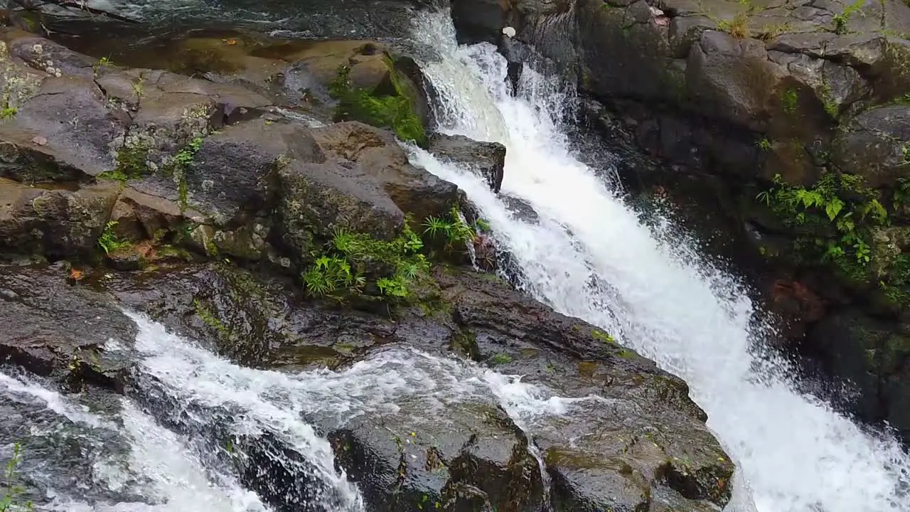 HD Hawaii Kauai slow motion pan left to right of a waterfall flowing left to right