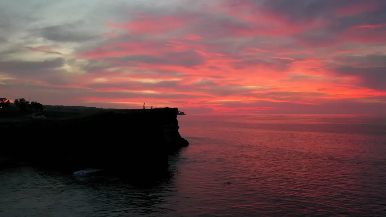 The beautiful fiery red sunset view in the horizon of Uluwatu in Bali Indonesia Aerial shot