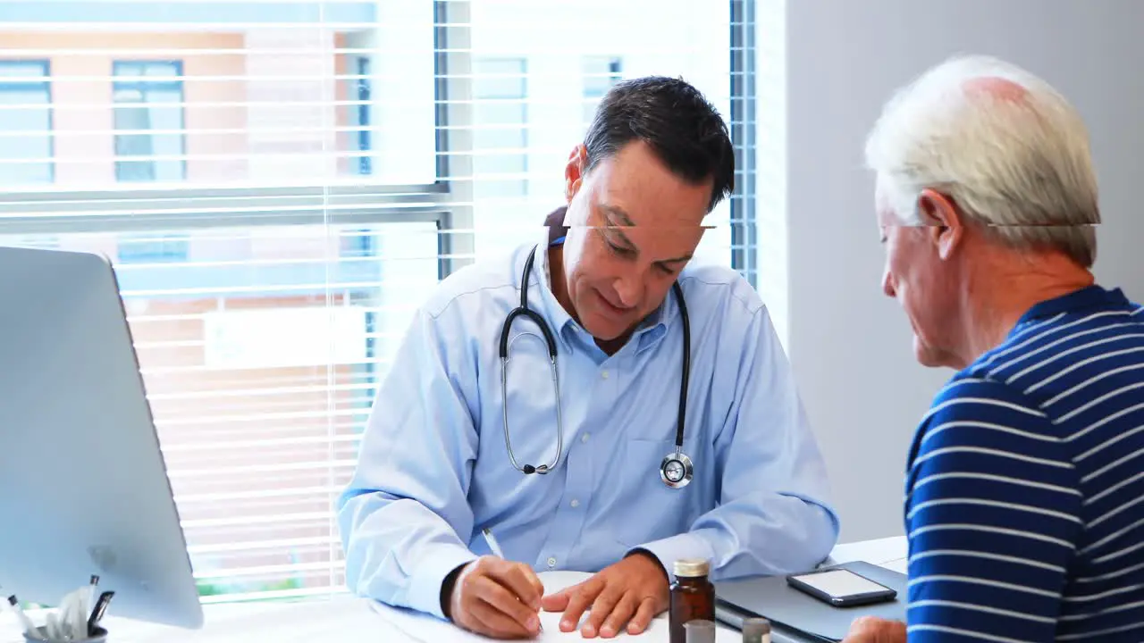 Doctor prescribing medicine to senior patient