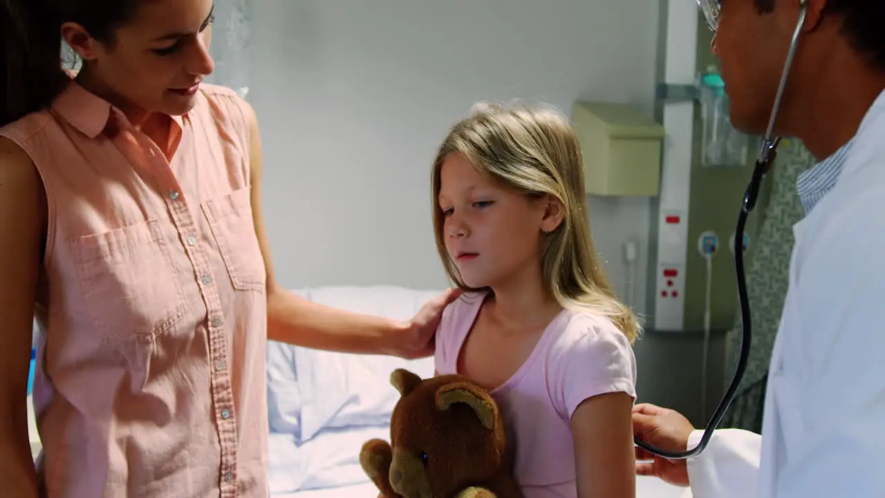 Male doctor examining girl patient with stethoscope 4k