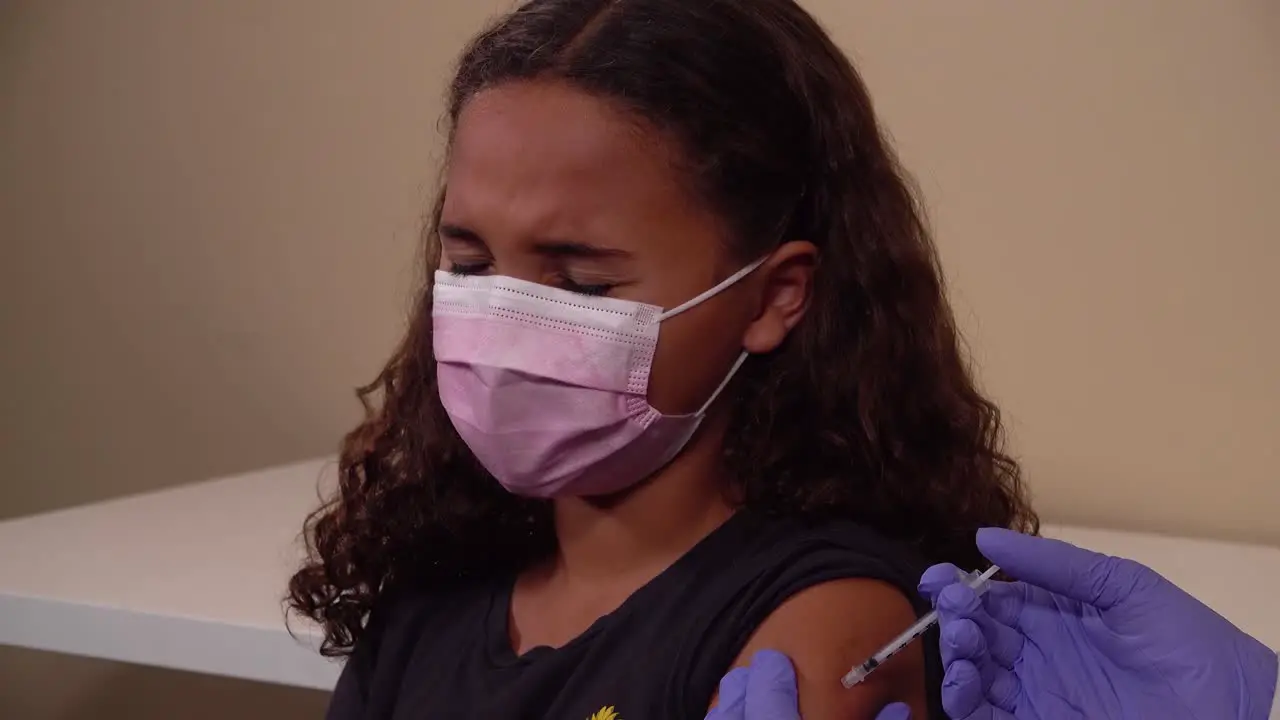 A Young Patient Receives The Coronavirus Covid-19 Vaccine Vaccination At A Medical Clinic