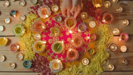 Overhead Shot Of Person Holding Burning Lamp Celebrating Festival Of Diwali 1