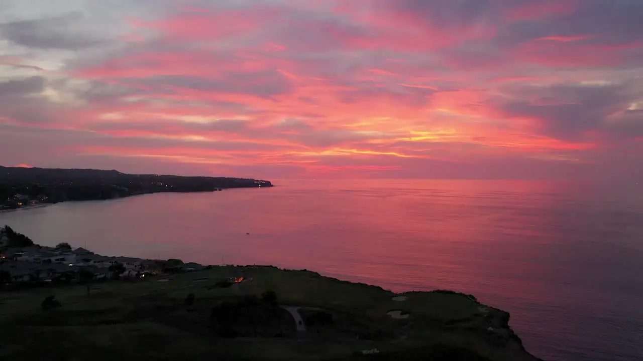 The beautiful landscape of Uluwatu Bali Indonesia with the fiery red sunset in the horizon Aerial shot