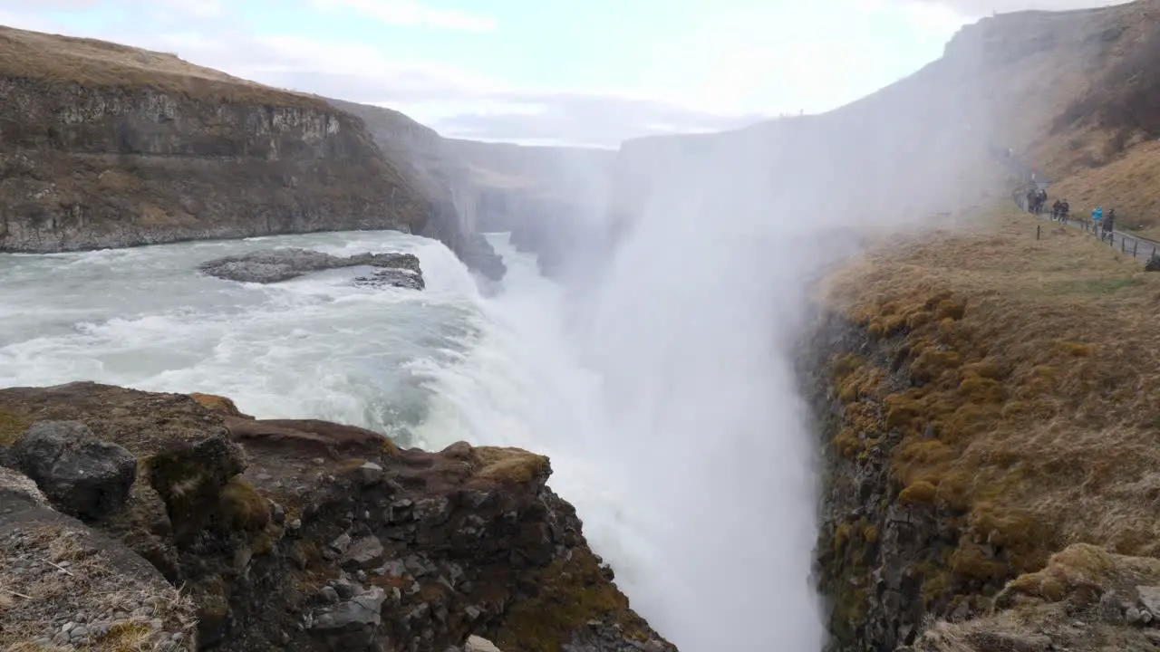 Steam moving upwards while water streaming down over the Gulfoss waterfall in Iceland