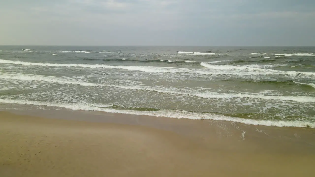 Beautiful waves of Wladyslawowo in Poland low aerial