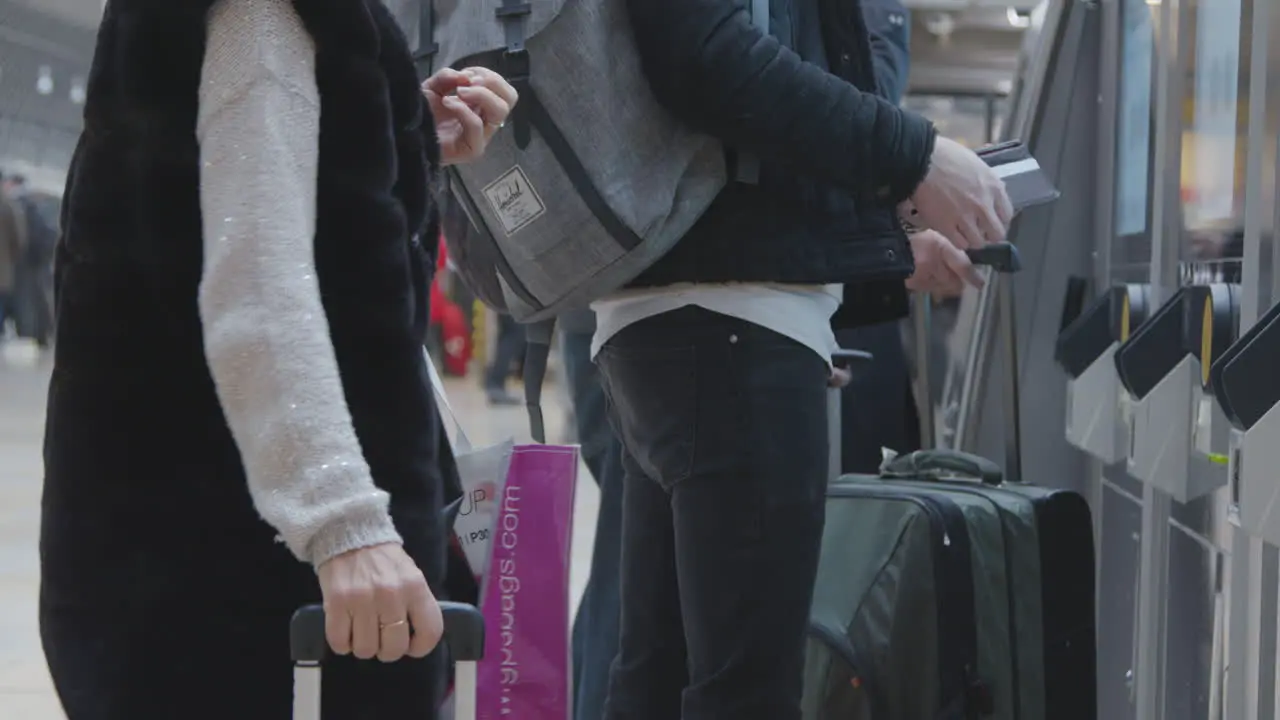 Man pays for ticket at ticket machine