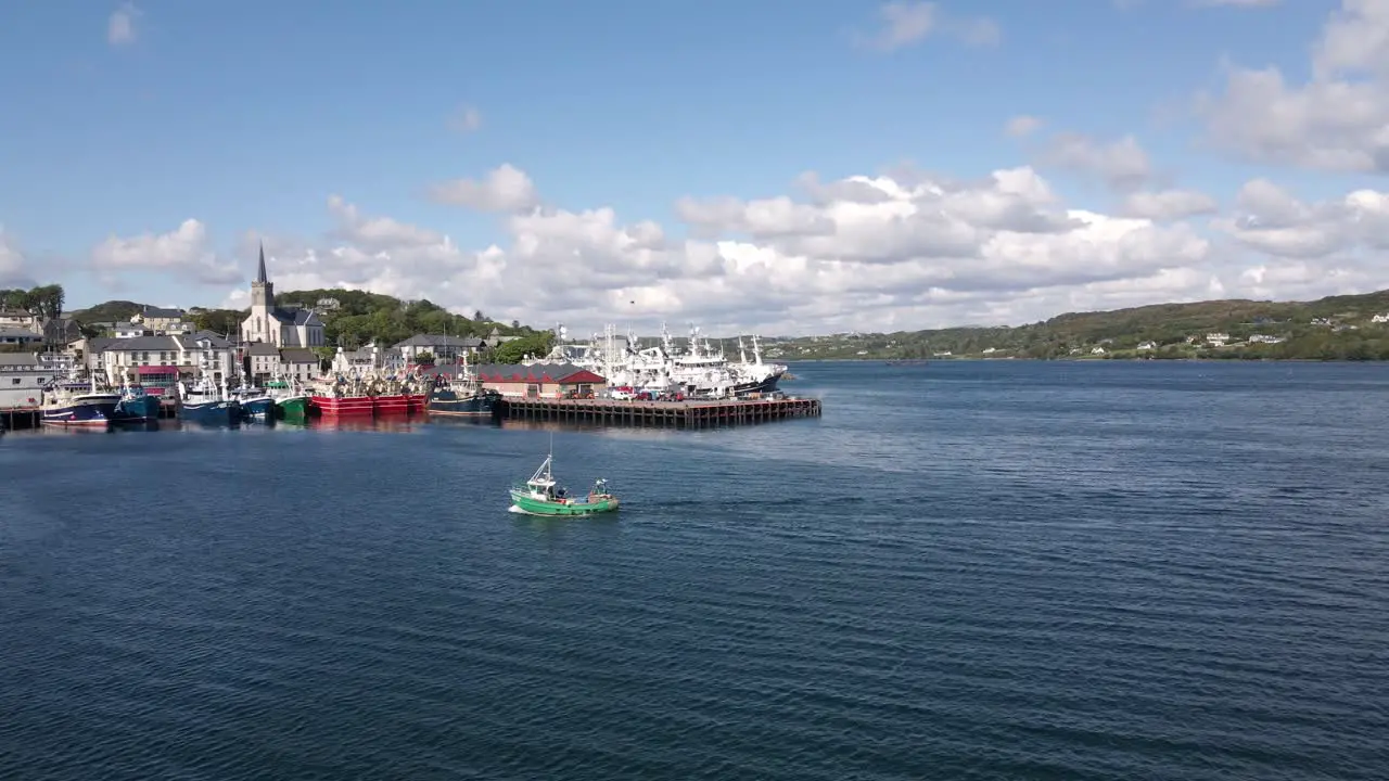 Drone shot of a small irish fishing boat coming into harbour