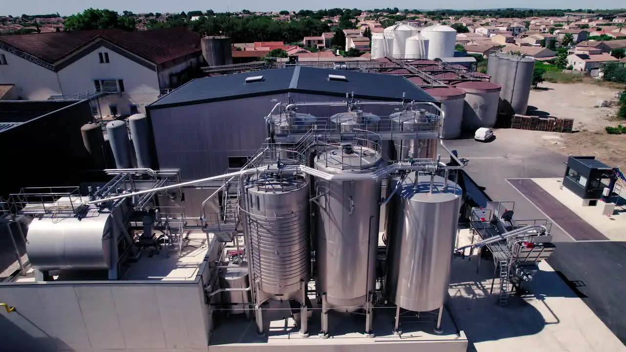 Aerial drone shot above steel cylinder in a industry area