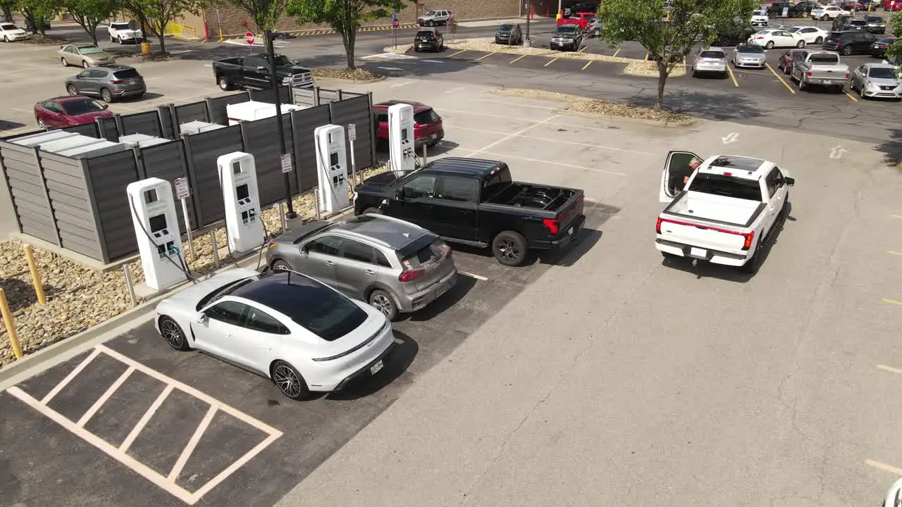 Electric cars charging in local charging station in USA aerial drone view