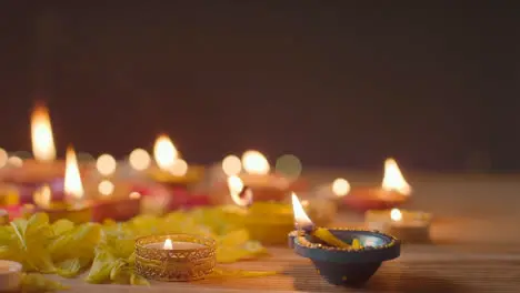 Burning Diya Lamps On Table Decorated To Celebrate Festival Of Diwali 2