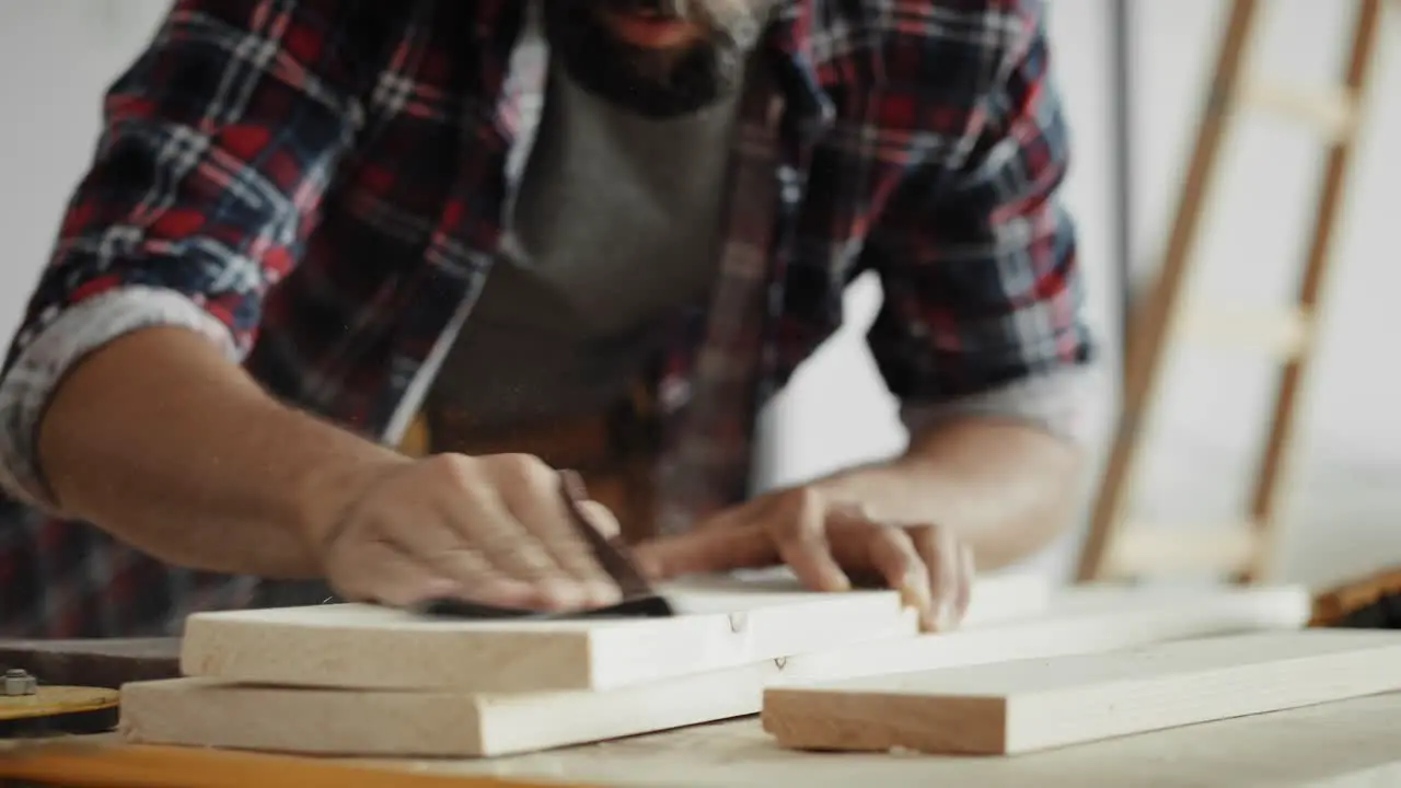 Tracking video of carpenter using sandpaper