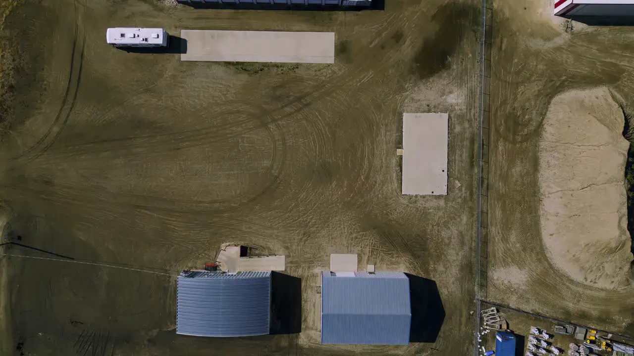 Top Down Aerial View of Agricultural Industrial Land Filled with Warehouses Implements and Equipment in Southwest Manitoba Canada