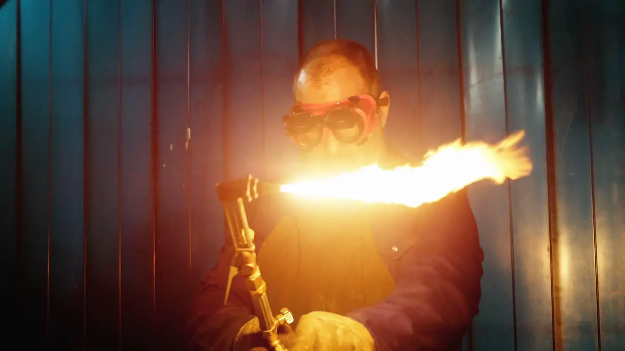 Male welder using welding torch