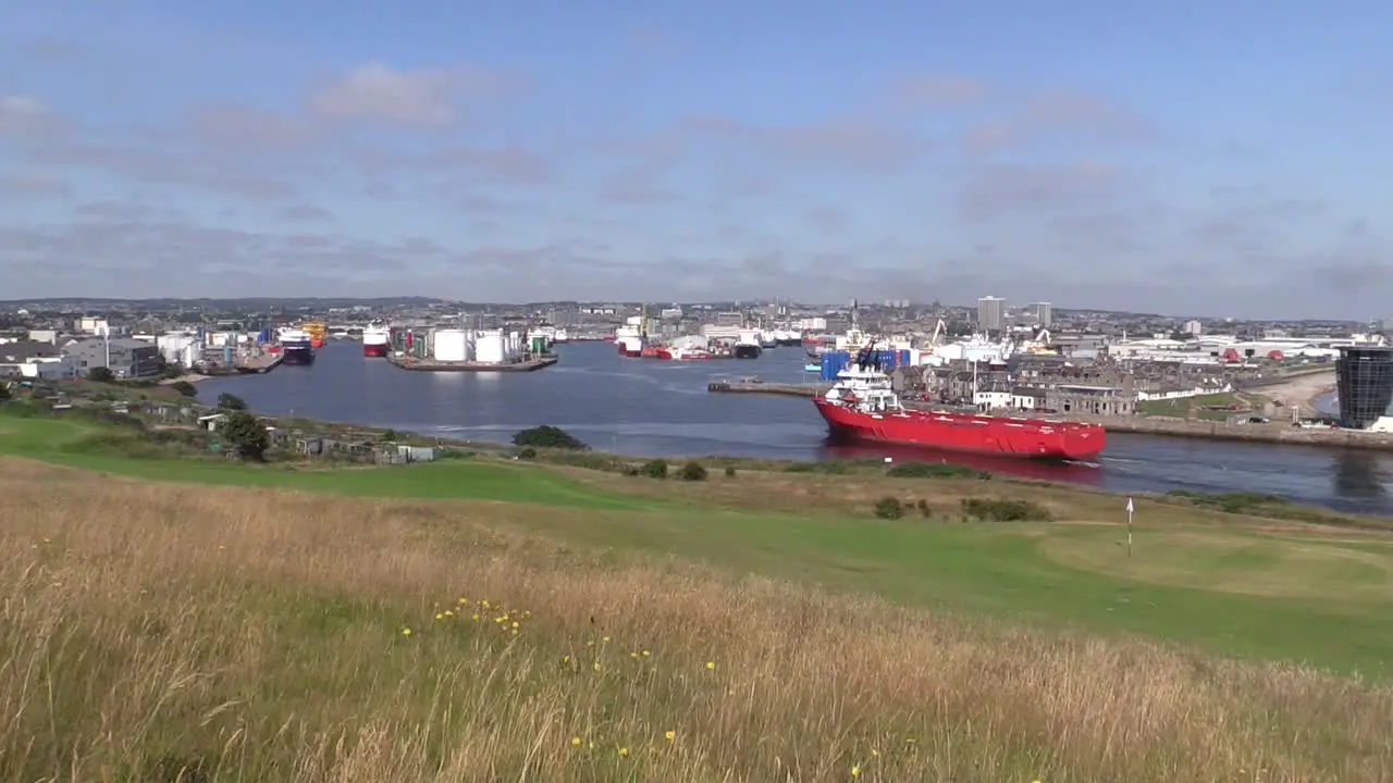 Aberdeen Harbour ship entering distant shot Aberdeen city in background