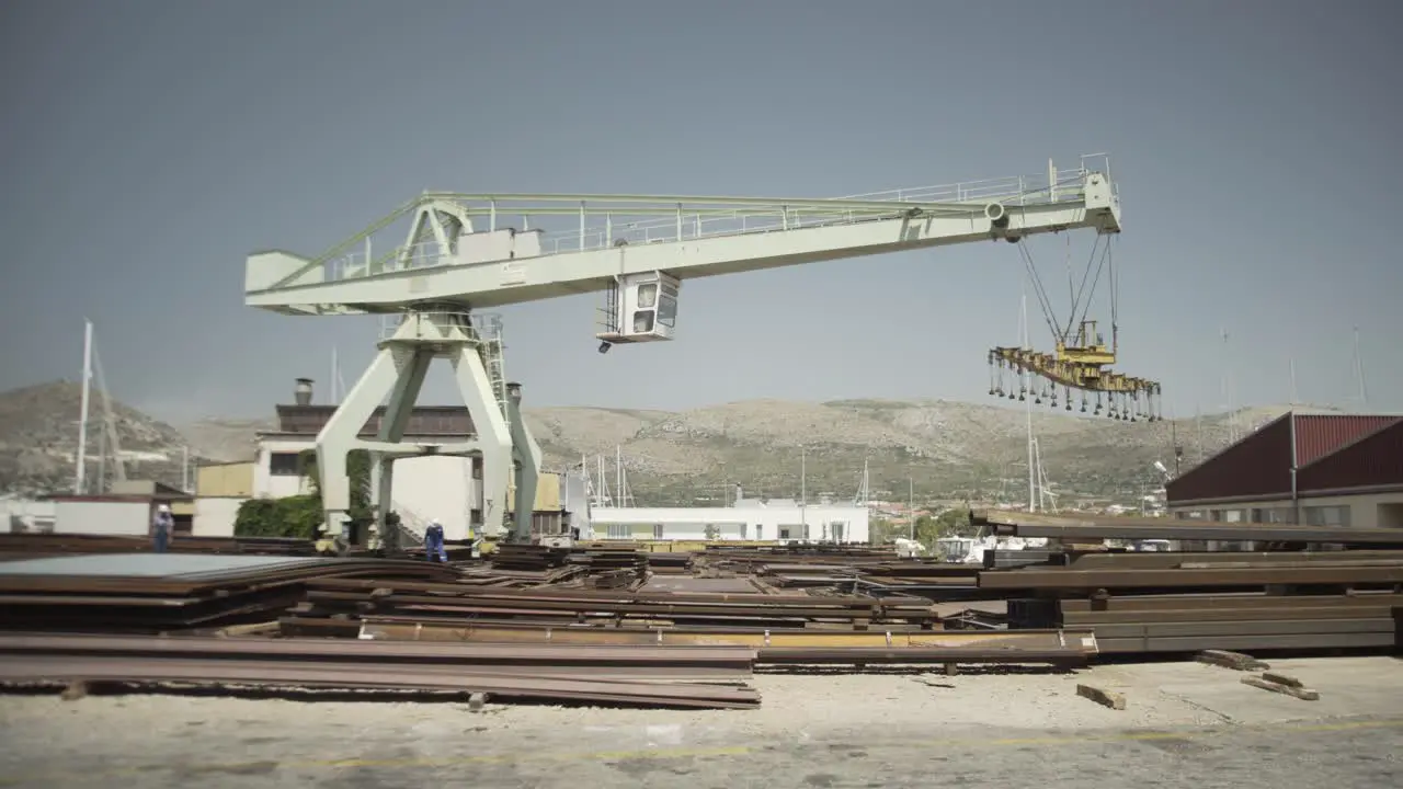 Shipyard exterior large crane and workers