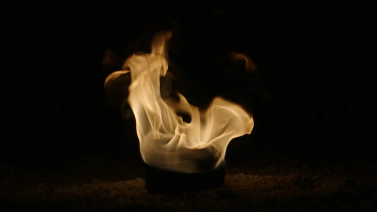 A fireball erupts before the start of a fire dance show