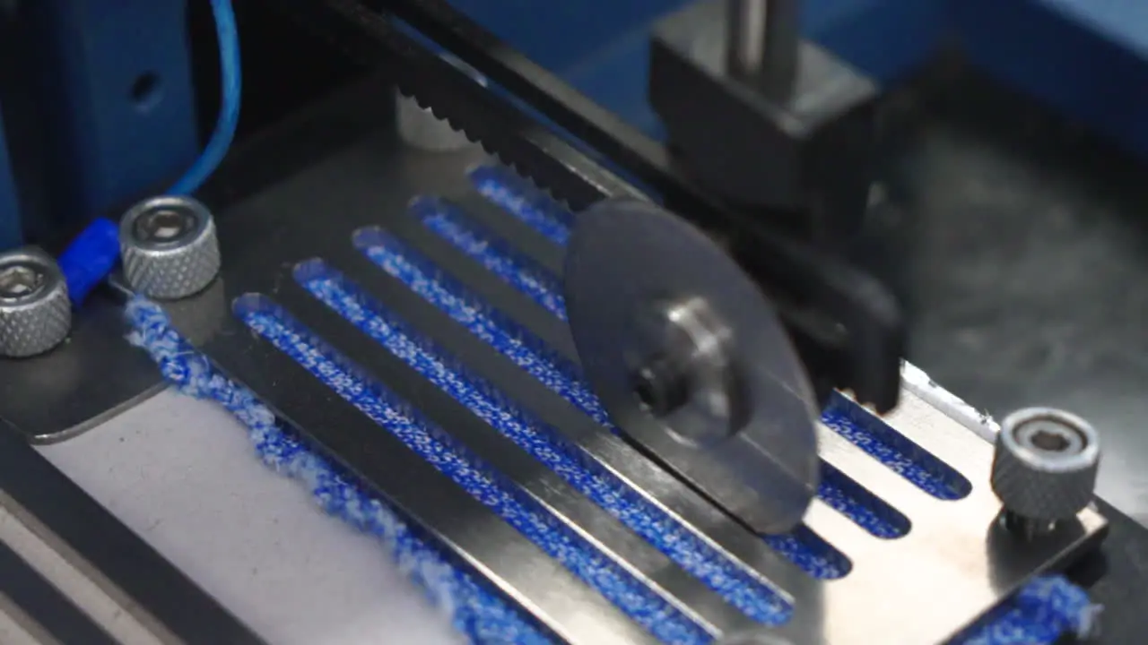 Testing a piece of fabric in an industrial machine closeup